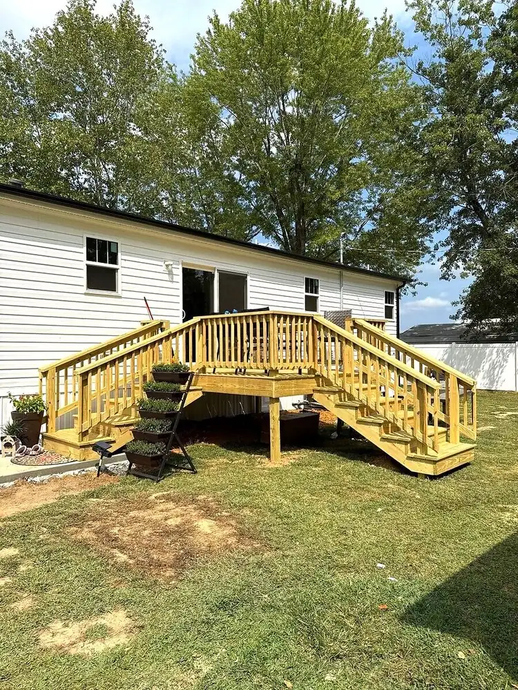 New wooden deck with stairs attached to white house in Murray, KY