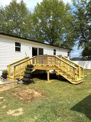 New wooden deck with stairs attached to white house in Murray, KY