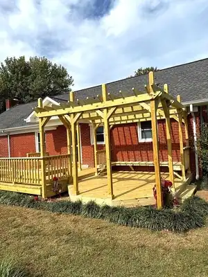 New wooden pergola over a deck attached to a brick house in Murray, KY