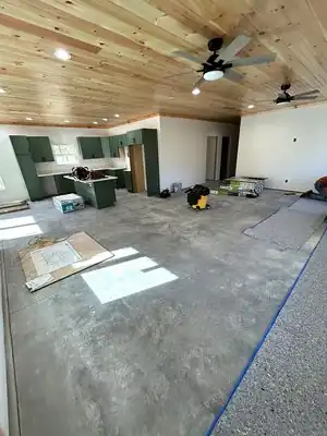 Open kitchen under construction with green cabinets and wood ceiling in Murray KY