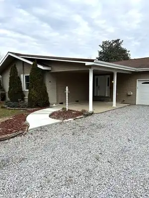 Completed front porch addition with curved walkway and gravel driveway in Murray, KY