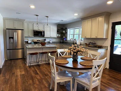Finished open-concept kitchen with granite island and dining area in Murray, KY
