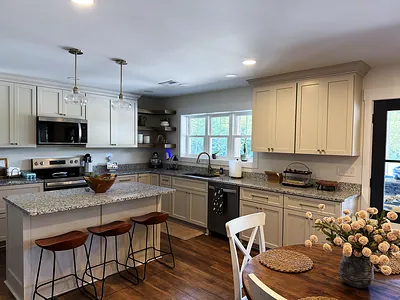 Custom kitchen with cream cabinetry, granite island, and open shelving in Western Kentucky